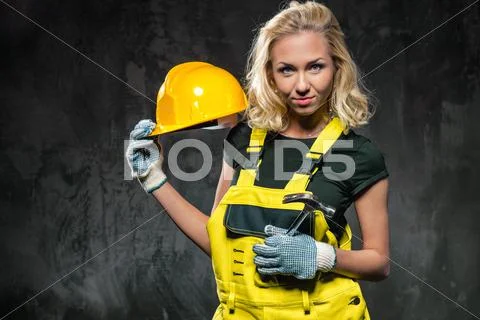 Attractive builder woman with protective helmet Stock Photos