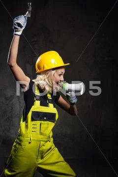 Attractive builder woman shouting through megaphone Stock Photos