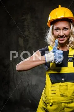 Attractive builder woman with thumbs up Stock Photos