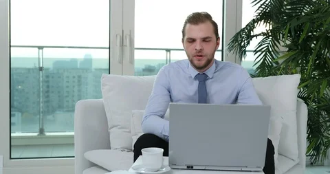 Attractive Business Man Affirmative Answer Giving Looking Interview Sit on Sofa Stock Footage 88009275