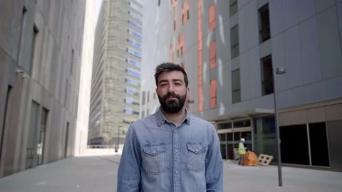 Attractive business man looking at camera outdoors near large office building Stock Footage 153251291