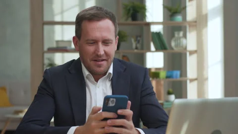 Attractive Business Man Using Mobile Phone Application for Work or Playing Game Stock Footage 217358647