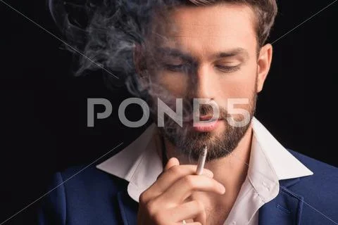 Attractive businessman enjoying cigar smoke Stock Photos