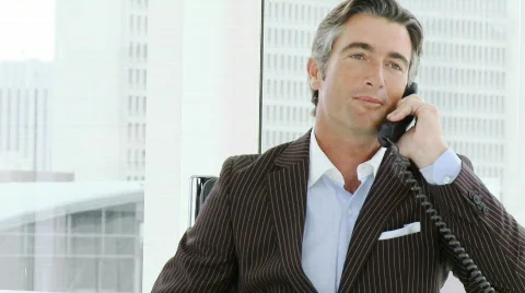 Attractive businessman on phone in office Stock Footage