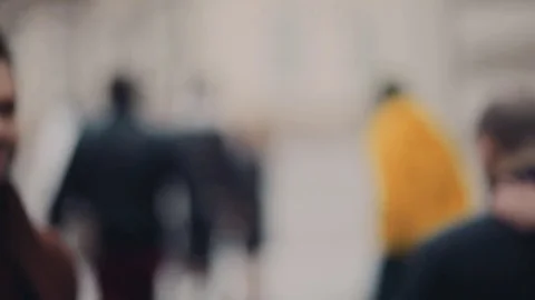 Attractive businessman walking down the crowded street, comes right to camera Video stock 74795485