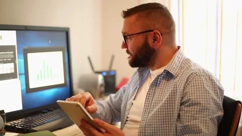 Attractive businessman working with tablet computer in office home 스톡 동영상 71659116