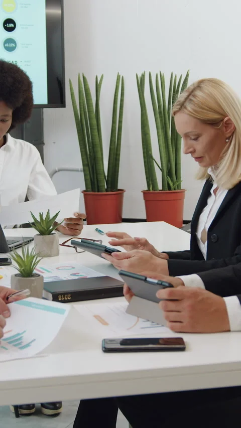 Attractive busy purposeful experienced multiracial corporate coworkers sitting a Stock Footage 330168088