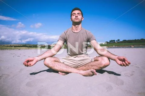 Attractive calm man relaxing with legs crossed Stock Photos