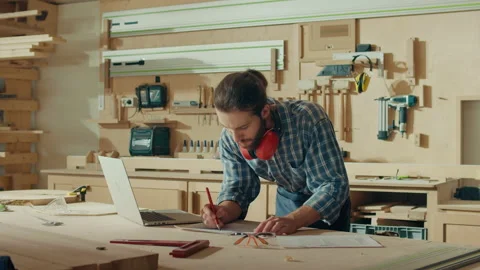 Attractive Carpenter Using a Laptop Making an Online Project in a Loft Studio Stock Footage 236473071