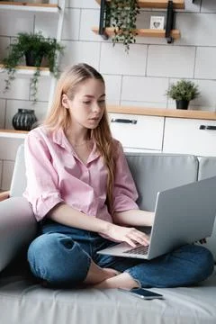 Attractive caucasian female using computer, look at device screen, distance work Stock Photos