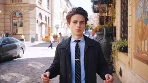 Attractive Caucasian guy throwing up hands, looking at camera. Portrait of young Stock Footage 92059126
