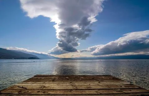 Attractive cloudy landscape with reflection over Lake Ohrid. Stock Photos