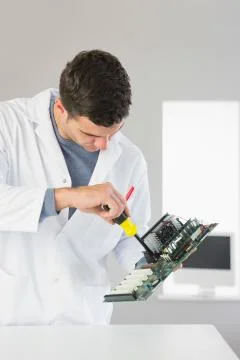 Attractive computer engineer repairing hardware with screw driver Stock Photos