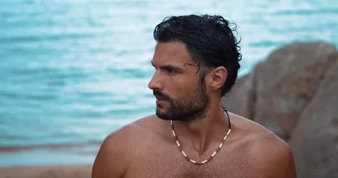 Attractive confident dark-haired bearded Caucasian macho man, with a wet body Stock Footage 219546941