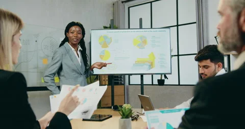 Attractive confident experienced mixed race businesspeople discussing Stock Footage 161107869