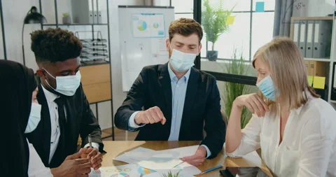 Attractive confident skilled mixed race businesspeople in facial medical masks Stock Footage 159608033