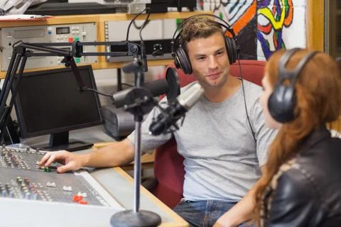 Attractive content radio host interviewing a guest Stock Photos