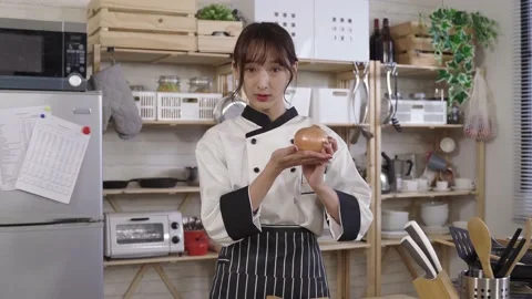 Attractive cook talking to camera Stock Footage 157523834