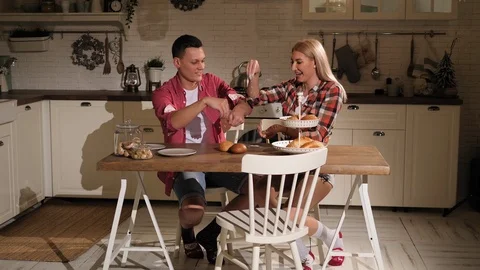 Attractive couple is cooking on kitchen and having fun with flour. Stock Footage 126419935