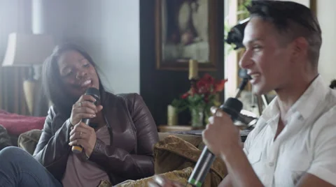 Attractive Couple Having Fun Singing Karaoke At Home Stock Footage 49624293