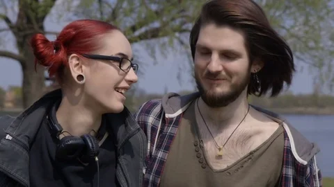 An attractive couple holding hands and enjoying a walking Stock Footage 71369991