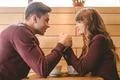 The attractive couple holding hands in the restaurant Photo