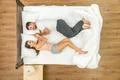 The attractive couple lay on the bed. View from above Photo