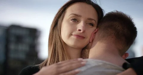 Attractive couple in love while girlfriend is hugging her boyfriend Stock Footage 79815430
