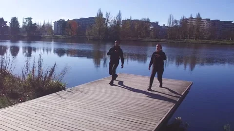 Attractive Couple Makes Legs Workout On a Pontoon Stock Footage 143649528