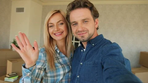 Attractive couple making selfie on camera in new apartment after moving in Stock Footage 78238785