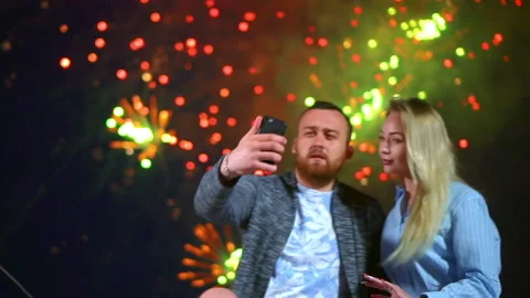 Attractive couple making selfie front phone on background fireworks with smile. Stock Footage 138011234