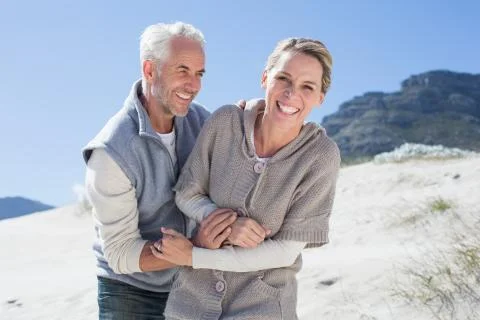 Attractive couple messing about on the beach Stock Photos