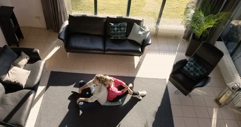Attractive Couple sitting back to back at home on the floor Video stock 86478113