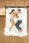 The attractive couple sleeping on the bed. View from above Photo