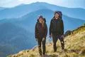 The attractive couple standing on the mountain Photo
