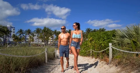 Attractive Couple Walks Path to Beach, Miami, Slow Motion Stock Footage 105816250