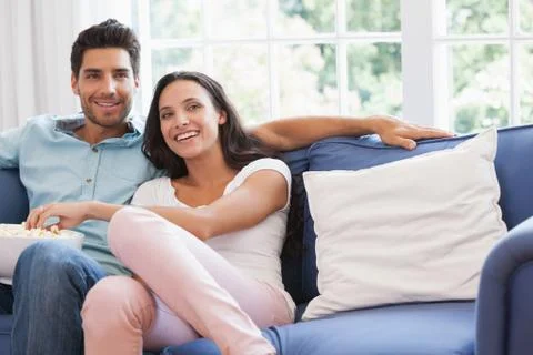 Attractive couple watching tv on the couch Stock Photos