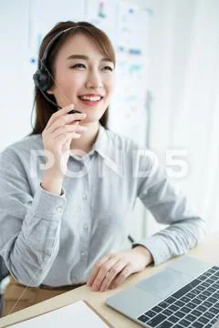 Attractive customer servicer working in office Stock Photos