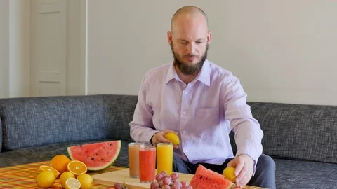 Attractive daddy Arranging his fruit platter for his family healthy breakfast Stock Footage 112025056