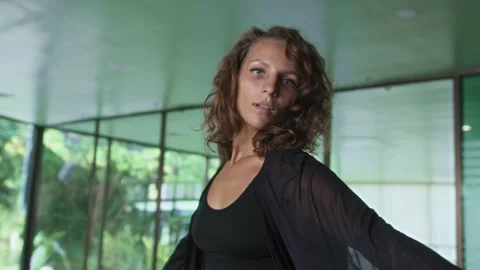 Attractive dancer spinning around performing choreography routines in empty hall Stock Footage 246360574