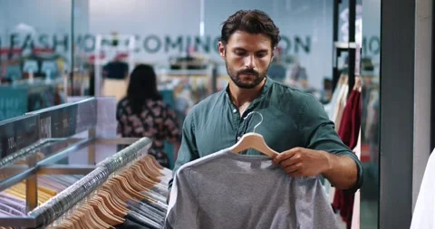 Attractive dark-haired bearded Hispanic macho man in casual wear, inspecting Stock Footage 219274278