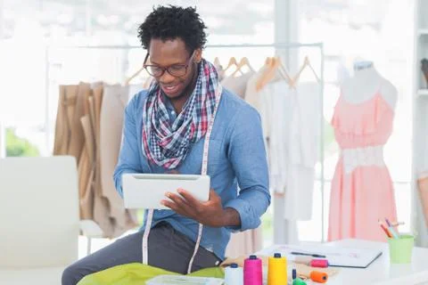 Attractive designer using tablet computer Stockfoto's