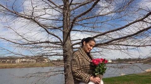 Attractive elegant  lady standing under a tree in the public park. Stock Footage 103486192