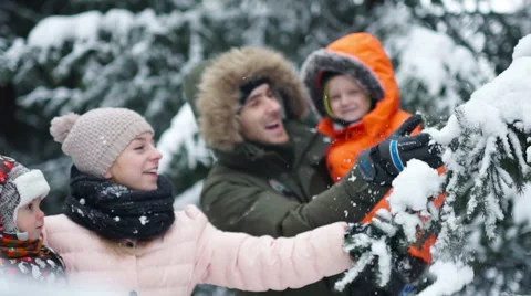 Attractive family having fun in a winter park Stock Footage
