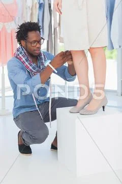Attractive fashion designer adjusting a dress Stock Photos