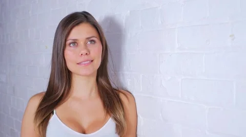 Attractive Female Doing Different Poses While Smiling And Leaning On Wall Stock Footage 62820375