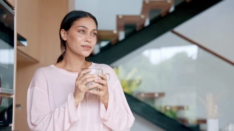 Attractive Female Drinking Hot Beverage To Start Her Day In Modern House Stock Footage 342580493