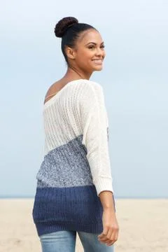 Attractive female fashion model looking over her shoulder and smiling Stock Photos