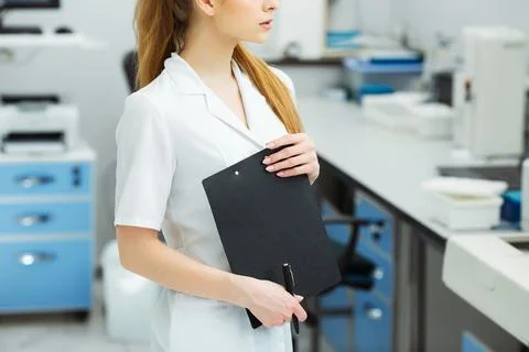 Attractive female lab worker making medical research in modern laboratory Stock Photos