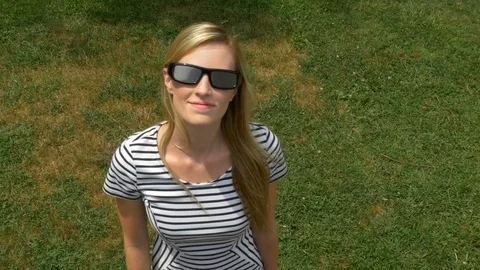 Attractive female looking at solar eclipse with special glasses Stock Footage 78492982